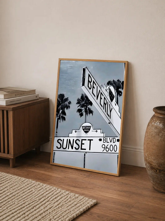 Stylized vintage print showing city skyline silhouettes against dramatic tropical sunset hues with embedded text details
