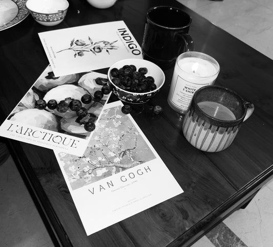 indigo prints - styled table with berries, a candle and monochrome art cards