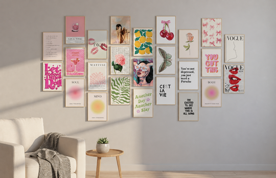 Wall collage kits displayed in a cozy neutral living room with framed pink, botanical and typography art prints.