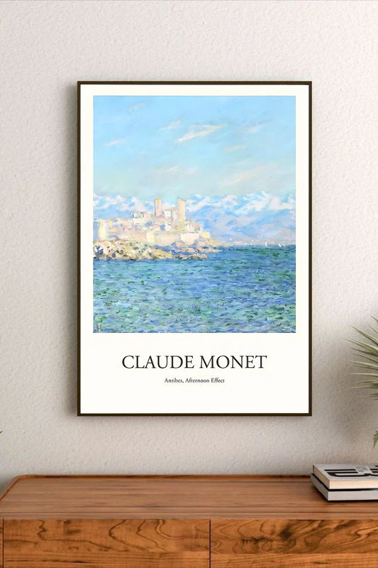 Watercolor style poster depicting Antibes coast in the afternoon, featuring bright blues, ochres, and whites. Landscape orientation