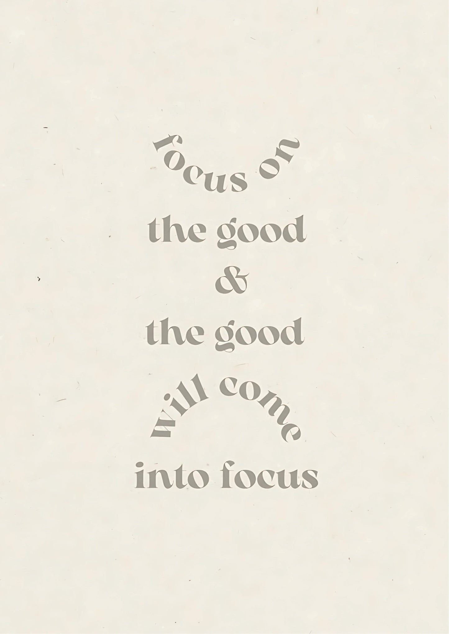 Text in muted grey on off-white background reads: "focus on the good & the good will come into focus" with curved lines above and below phrases