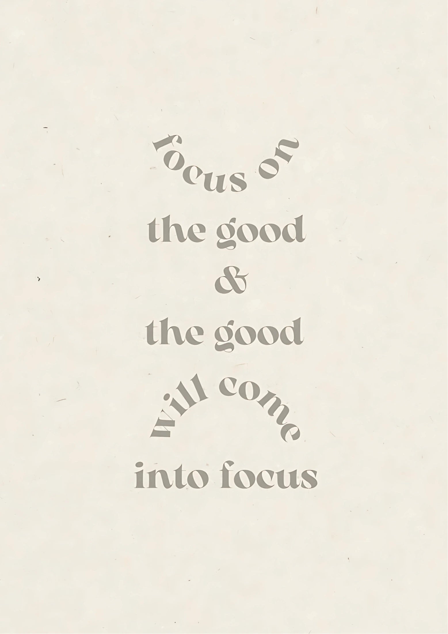Text in muted grey on off-white background reads: "focus on the good & the good will come into focus" with curved lines above and below phrases