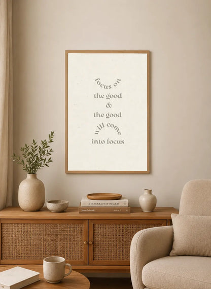 Portrait poster with minimalist typographic design in muted gray on off-white background, reading "focus on the good & the good will come into focus"