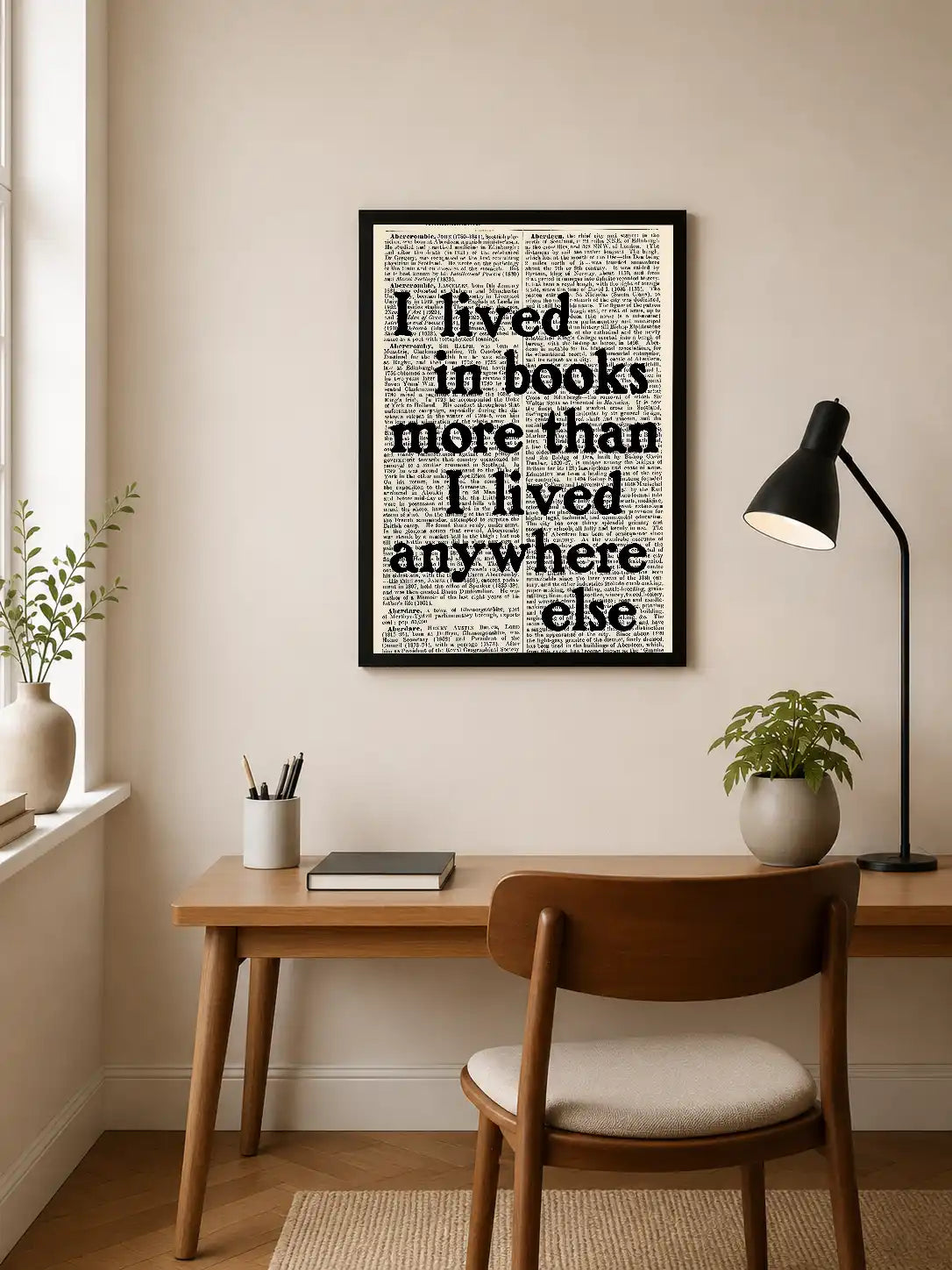 Black serif text reading "I lived in books more than I lived anywhere else" overlaid on dense dictionary page background. Portrait orientation