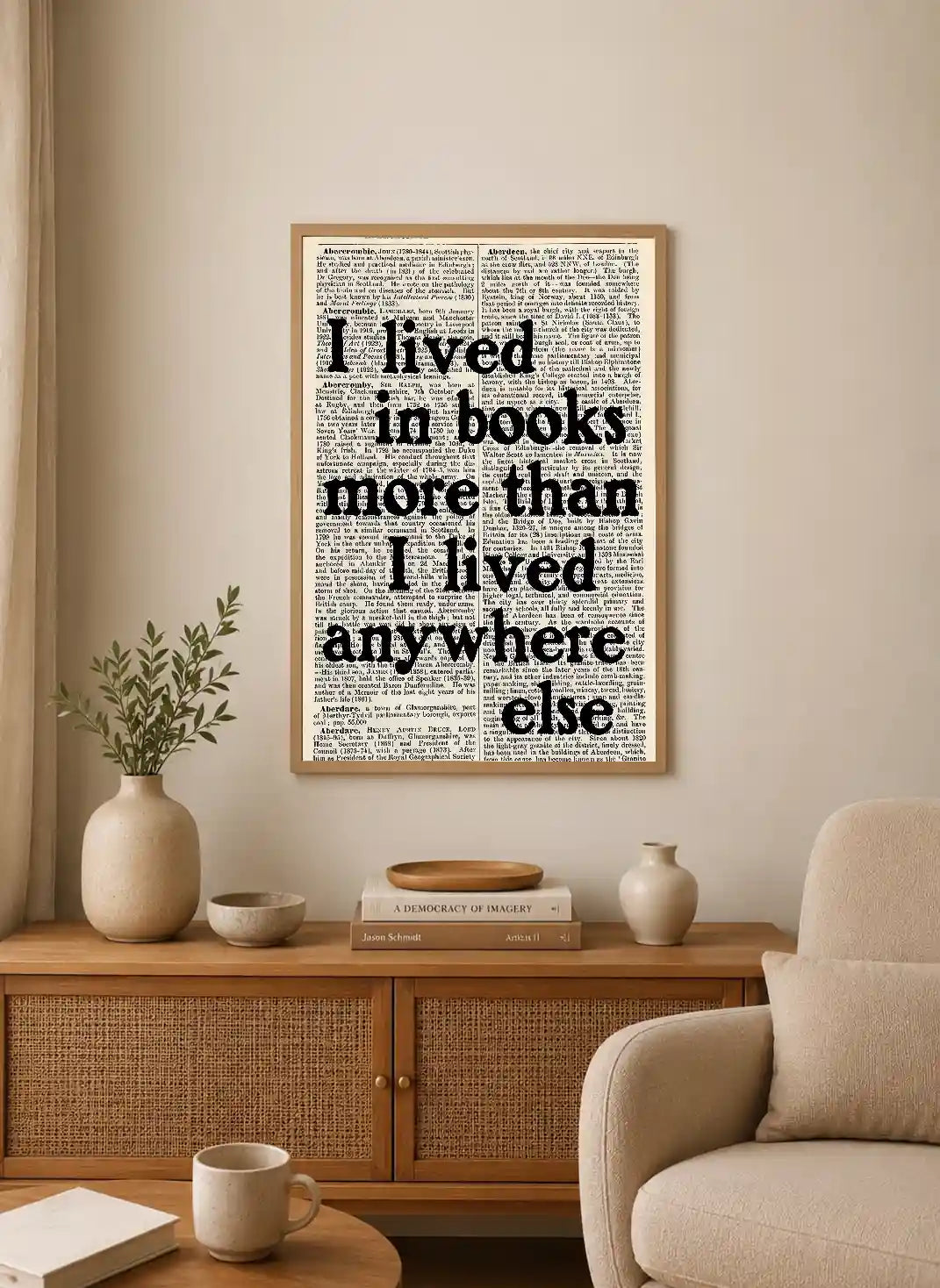 Black sans-serif text on a background of faded dictionary pages, reading "I lived in books more than I lived anywhere else"