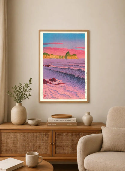 Portrait print depicting a coastal scene with pink and purple skies, waves, rocky shores, and distant cliffs in soft, stylized colors
