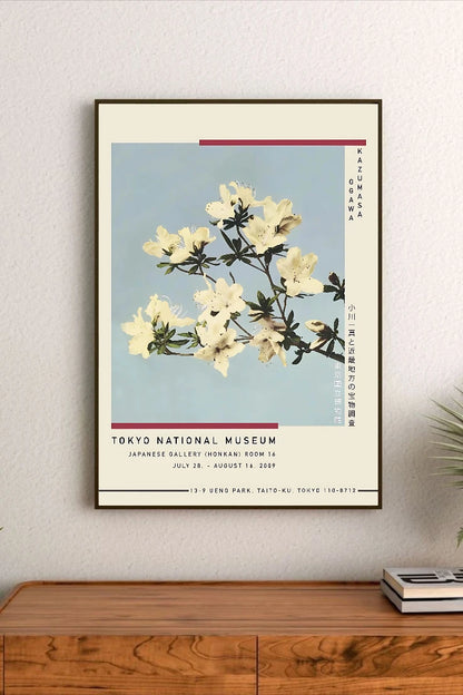 Portrait poster featuring white azalea blossoms against a pale blue background, with vertical Japanese and English text alongside minimalist red