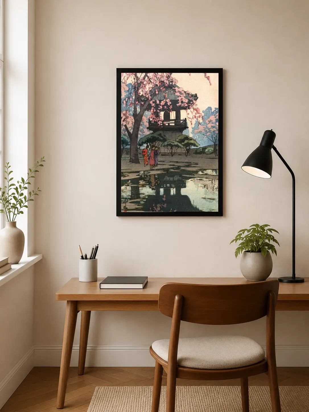 Portrait print depicts traditional Japanese pagoda under pink cherry blossoms with figures walking on a reflective path, rendered in soft watercolor