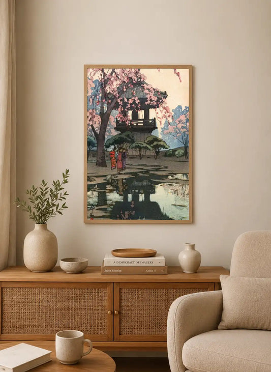 Portrait print depicting a Japanese torii under cherry blossoms with two figures walking past, rendered in soft pink, blue, and green tones