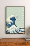 Portrait poster featuring a stylized wave with deep blues and cream highlights, vertical "HOKUSAI" text in white, traditional Japanese wave motif
