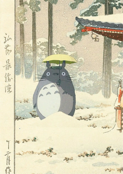 Totoro stands in snow, holding a yellow umbrella, against a backdrop of trees and a temple roof, with vertical Japanese calligraphy on left side