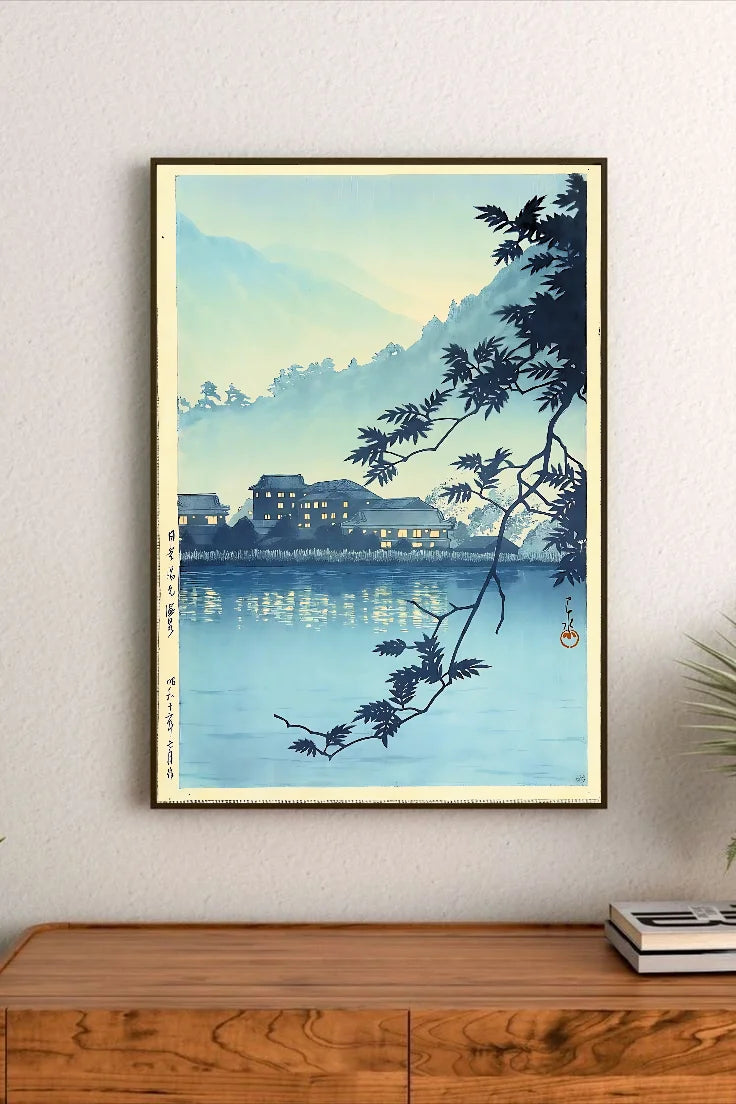 Portrait print featuring tranquil blue-toned landscape with silhouetted branches, distant illuminated Japanese buildings, and reflective water