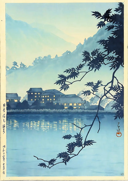 Blue-toned landscape featuring silhouetted branches, reflective water, and illuminated Japanese-style buildings against misty mountains