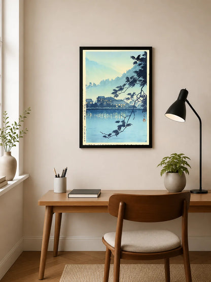 Blue-toned landscape with silhouetted maple branches framing distant Japanese buildings reflected in calm water
