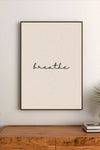 Portrait poster with minimalist black cursive script reading "breathe" on a textured cream background