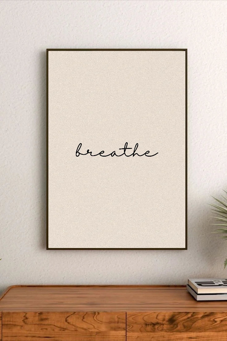 Portrait poster with minimalist black cursive script reading "breathe" on a textured cream background
