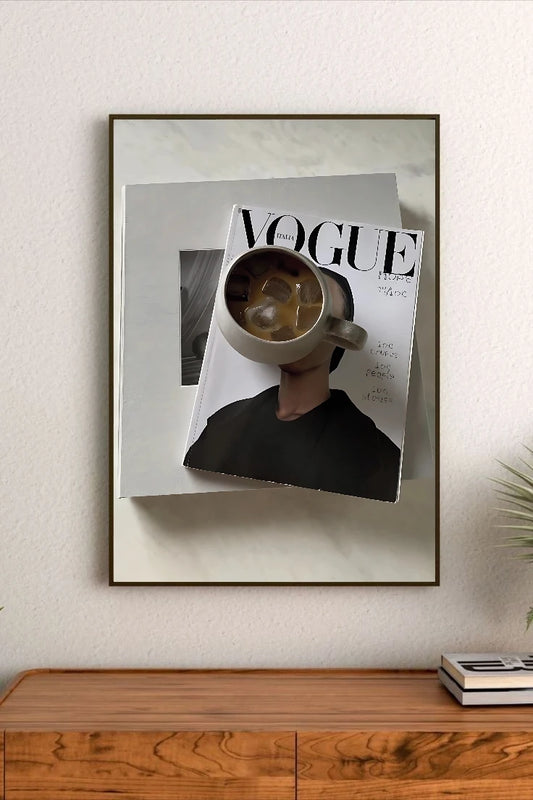 Portrait poster featuring a person holding a mug of iced coffee over a Vogue Italia magazine cover with bold typography and minimalist design