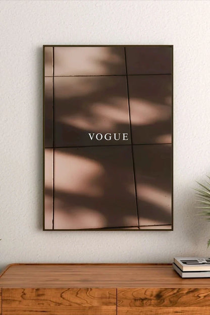 Monochromatic abstract wall art with layered distressed text, symbols, and dark geometric shapes against a pale background surface