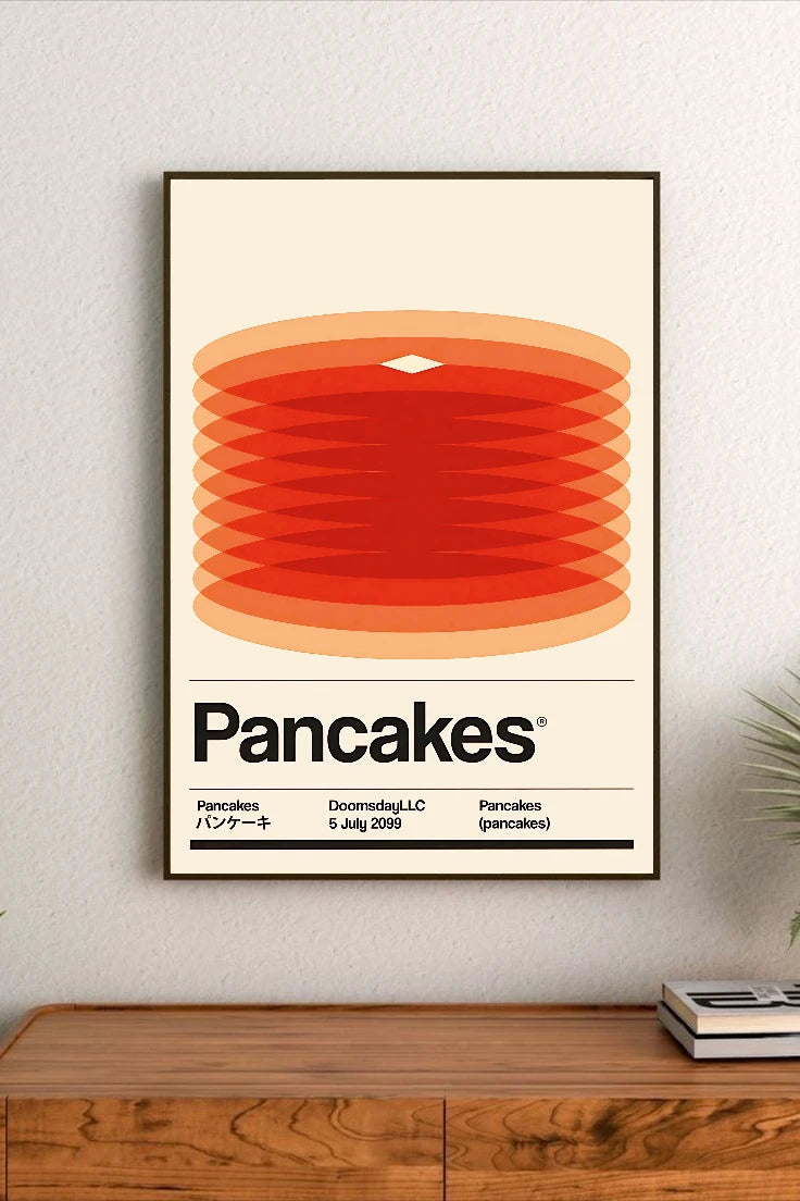 Portrait poster featuring stacked pancake rings in gradient reds and oranges, with bold black "Pancakes" title and three lines of smaller text below