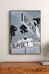 Retro poster artwork featuring a vibrant sunset gradient of orange and pink over urban elements and stylized typography