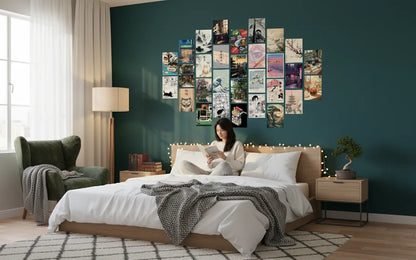 Woman reading a book on a bed with a wall of framed pictures above her