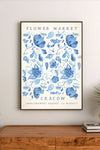 Botanical illustration of clustered flowers and leaves in soft blues, creams, and muted purples, arranged vertically in a detailed bouquet composition